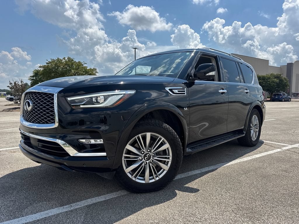 2020 INFINITI QX80 LUXE in Black Obsidian — front three-quarter view