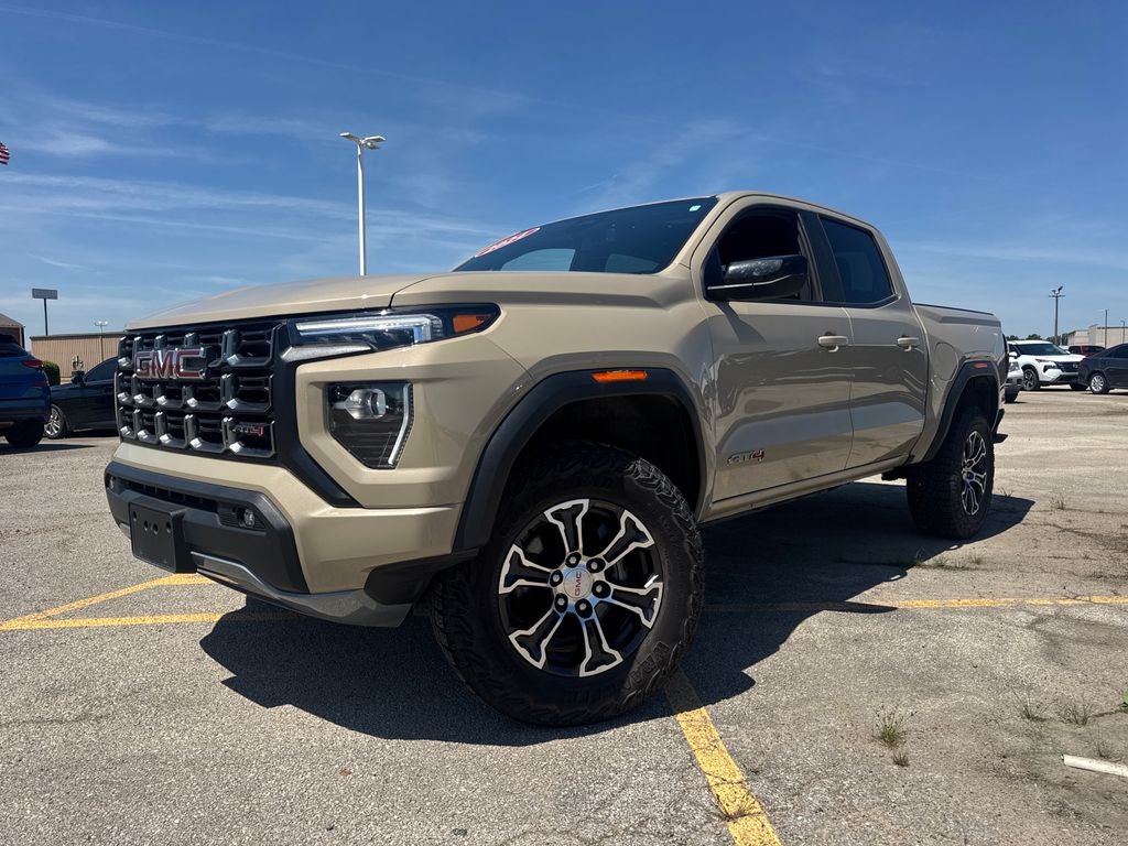2024 GMC Canyon AT4 in Desert Sand Metallic — front three-quarter view
